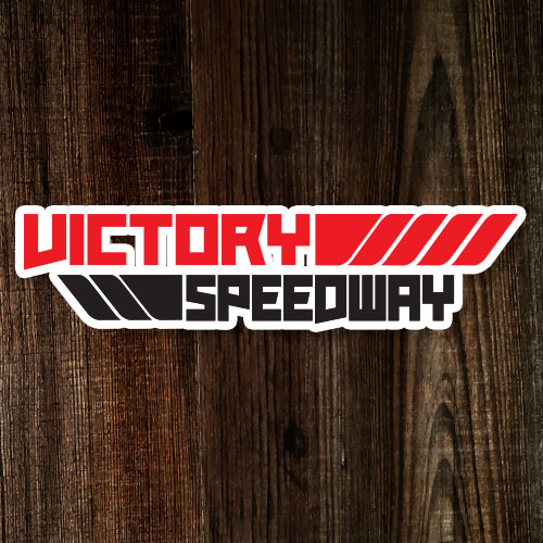 Victory speedway logo on a wooden background.